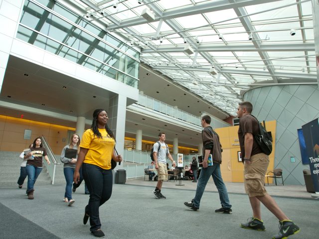 seven students walk through Science Hall