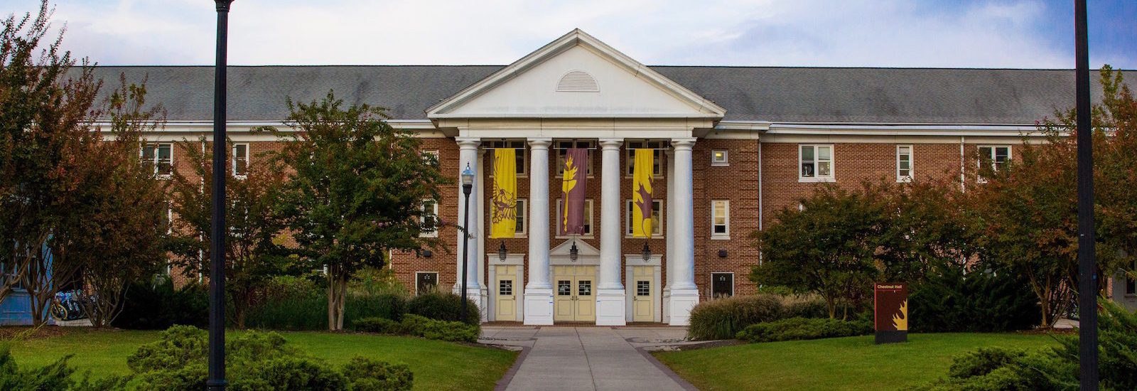 Brick residence hall Chestnut Hall, with white columns in front
