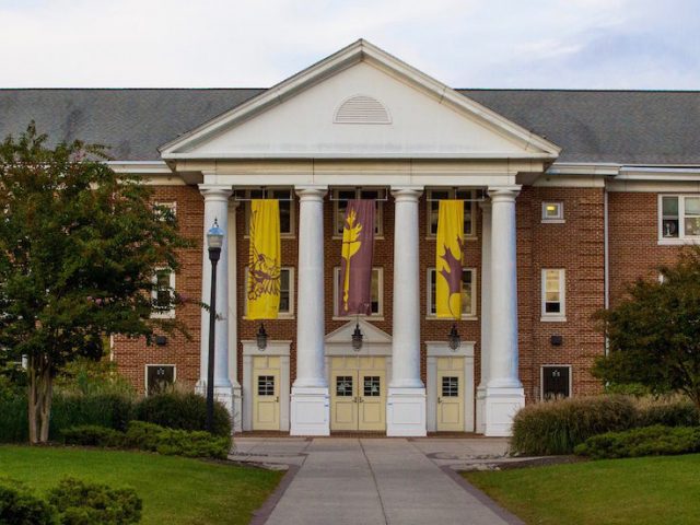 Brick residence hall Chestnut Hall, with white columns in front