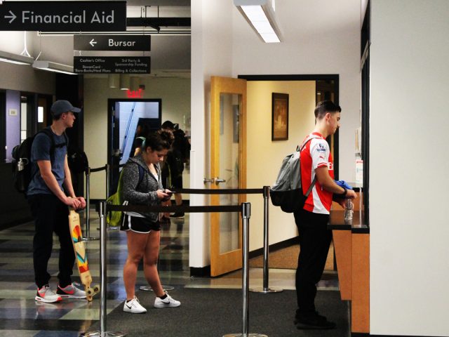 students wait in line for Financial Aid office