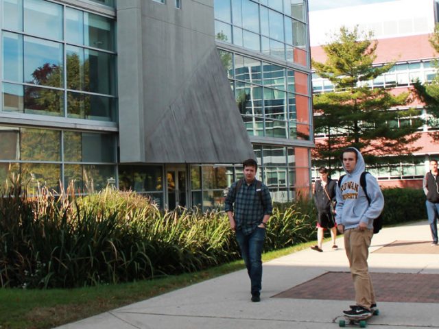 Students rush to classes on Monday morning passing Savitz Hall