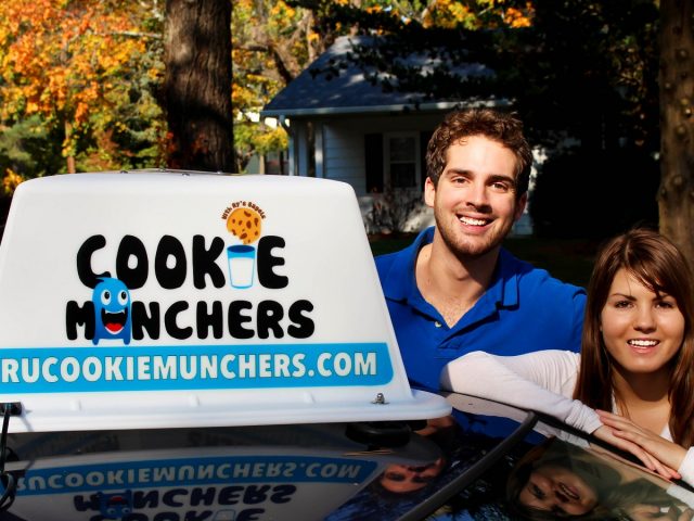 Cassie Aran and Brandon Lucante pose with their new car sign for "Cookie Munchers"