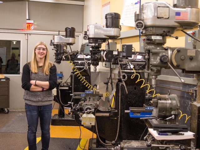 biomedical engineering major Haley stands in a workshop lab