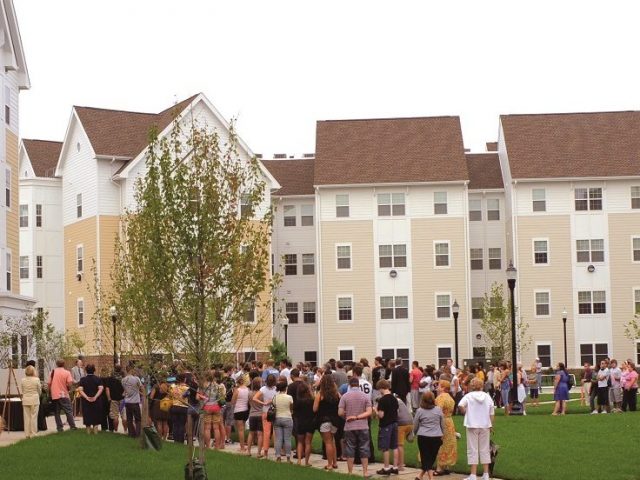 people stand outside of Rowan Boulevard Apartments