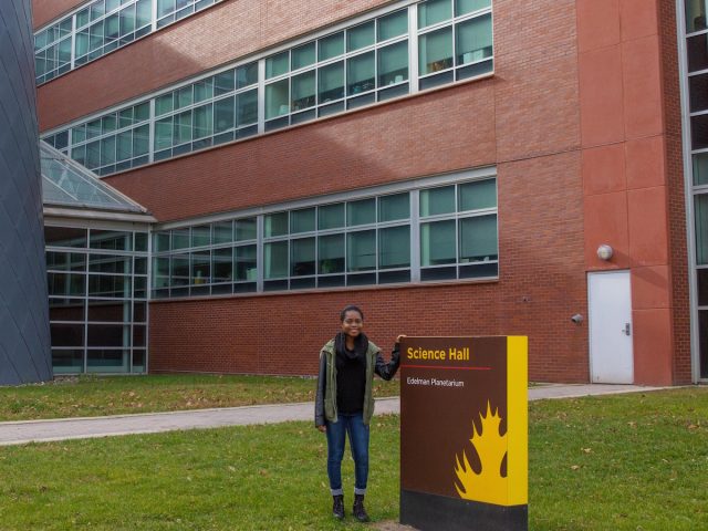 student poses at science center