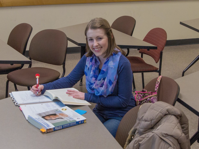 student preps for exam sitting at a table