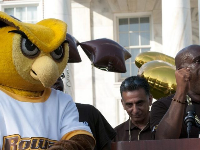 Rowan mascot on stage in front of Bunce to welcome students, surrounded by students