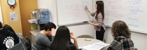 A tutor teaches three tutees at Rowan Tutoring Center