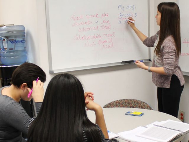 A tutor teaches three tutees at Rowan Tutoring Center