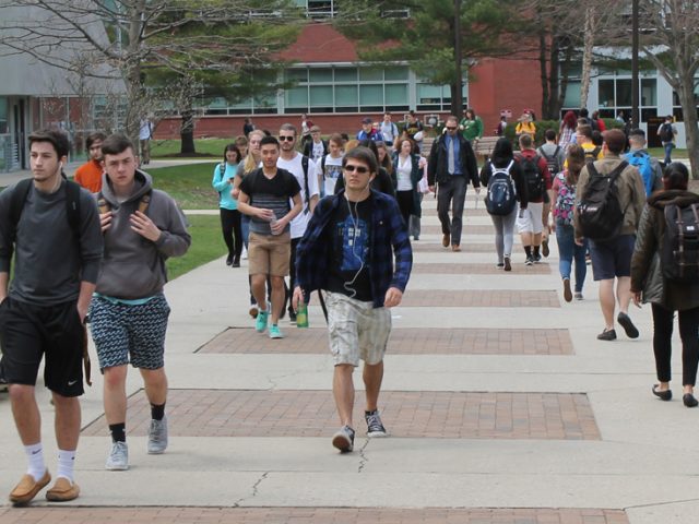 Students walking on Campus in Front of the Savitz Hall