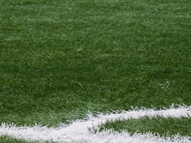 green grass with white painted lines for field hockey