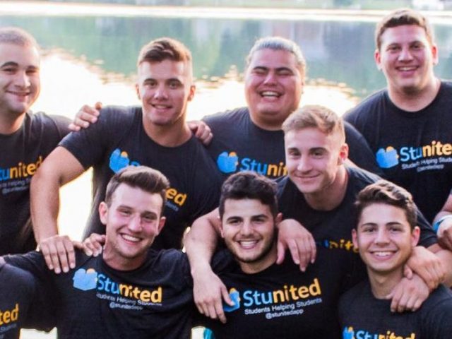 group of students wear club t-shirts, huddled in a group