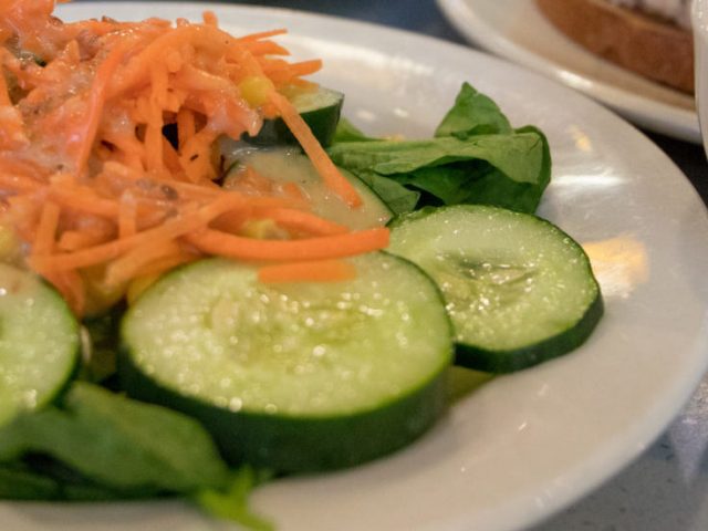 cucumbers, shredded carrots on a salad on a white plate