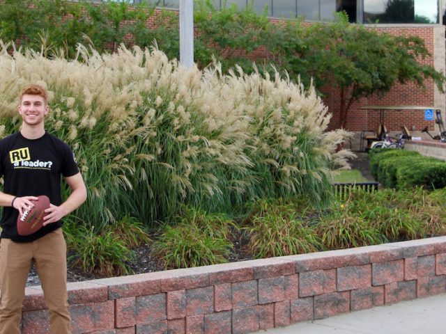 Joe with football outside of Rec Center