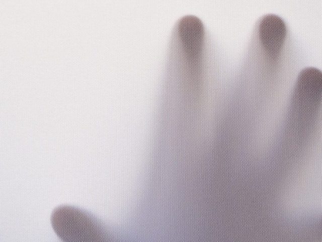 spooky hand reaches out through a white mist