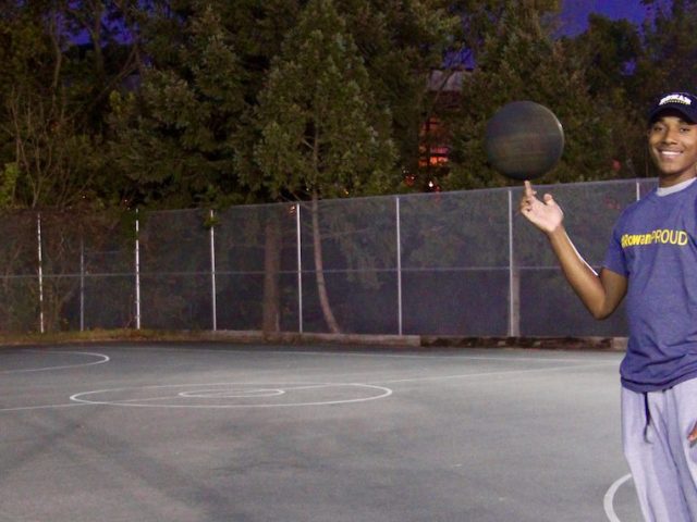 Nasir spinning the basketball on his finger at the courts