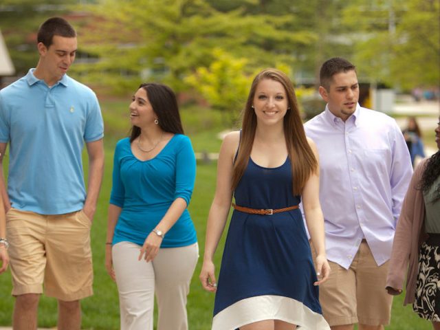 Rowan University students walking outside of Campbell Library