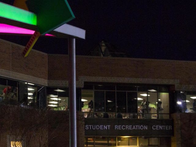 Front of Rec Center at night, with brightly illuminated abstract art in front