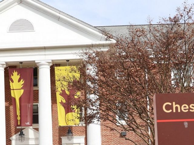 brick exterior and white columns of Chestnut, with brown and yellow flags