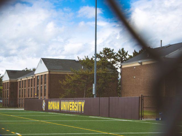 Rowan University sign on turf field outside Rec Center