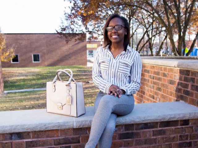 Rowan student Destiny sitting outside of Chamberlin student center at Rowan University