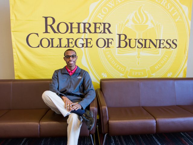 Davon sitting on the couch inside the Rohrer Business of college at Rowan University in Glassboro NJ