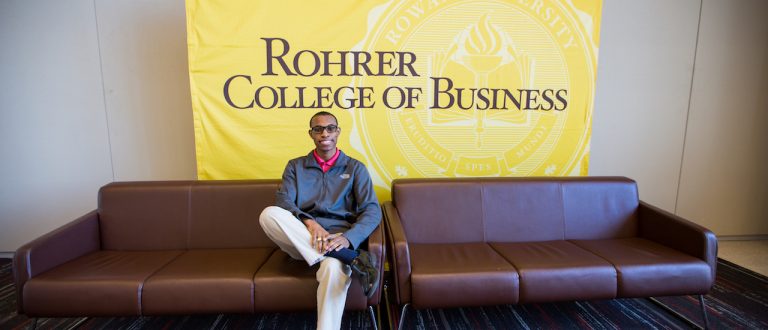 Davon sitting on the couch inside the Rohrer Business of college at Rowan University in Glassboro NJ