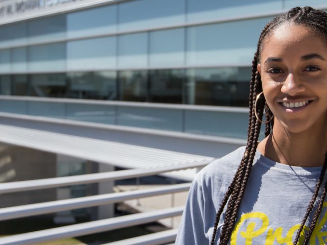 Sidney stands on the outside balcony of the new engineering building at Rowan University