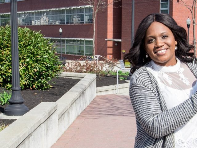 Brandi from Financial Aid holds a multi colored beach ball while in front of Science Hall at Rowan University