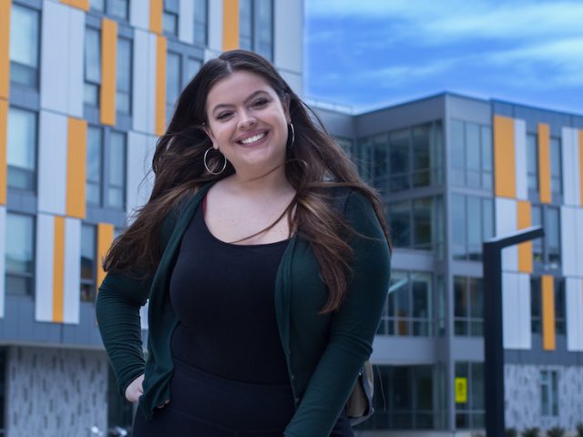 Rowan University Student outside holly pointe commons