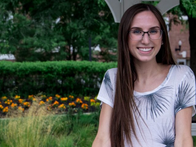 Molly, a transfer student, standing in a gazebo near Bunce.