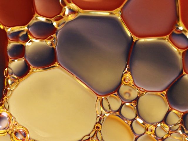 close up of amber colored bubbles in water