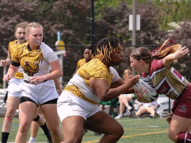 Rowan University Rugby during a match, in action defending a ball from the other team.