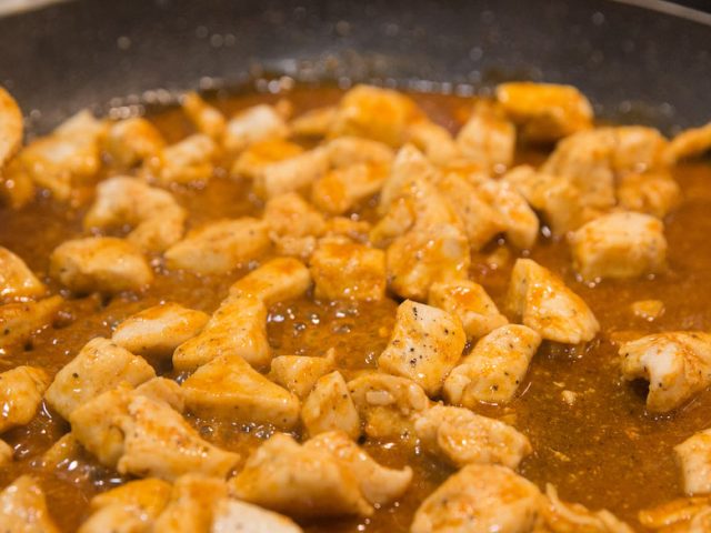 chicken cooking in pan