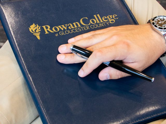 business folder and student at Rowan University