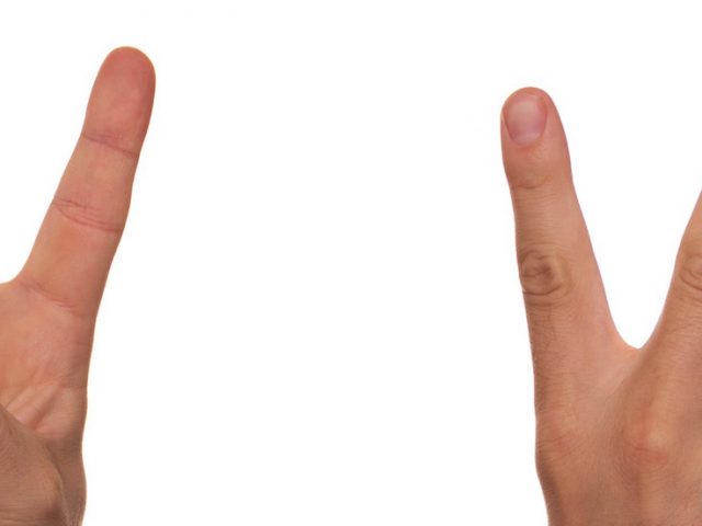 close up of fingers making peace sign with two hands