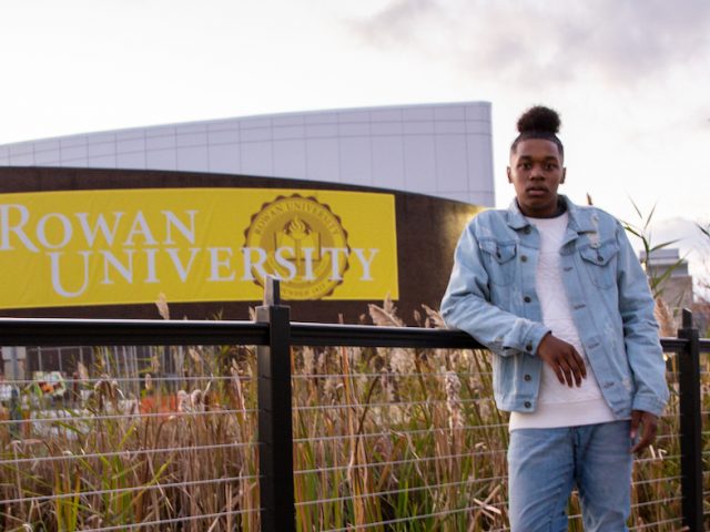 Student outside Wilson Hall on bridge