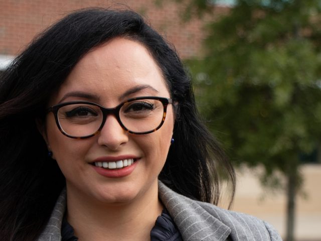 close up of business woman with brick building in the background