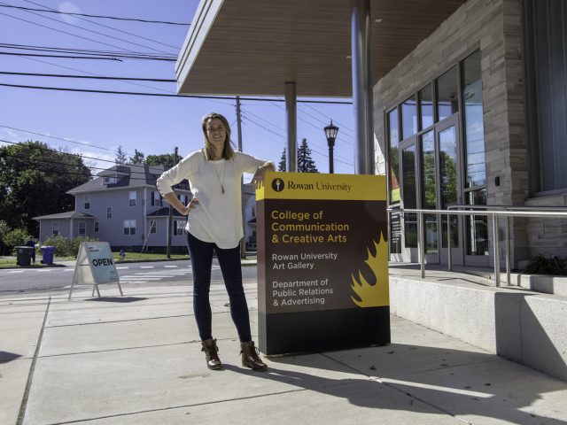 A female student standing outside 301 High Street