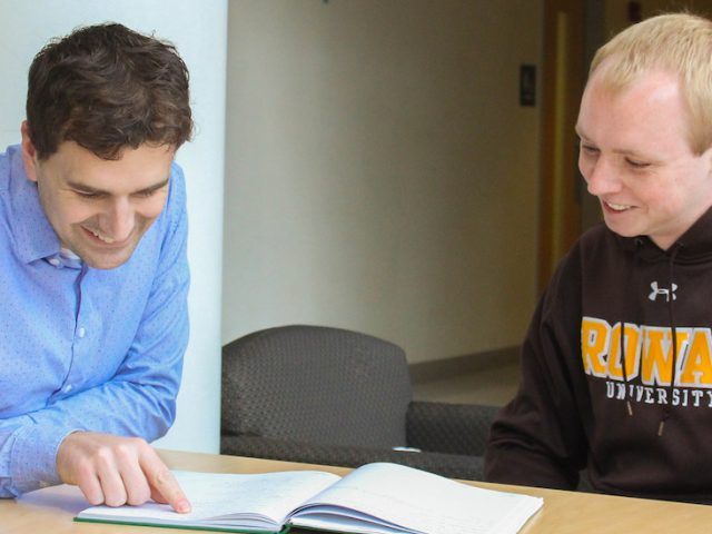 Analytical chemist James Grinias at Rowan University sits with a student