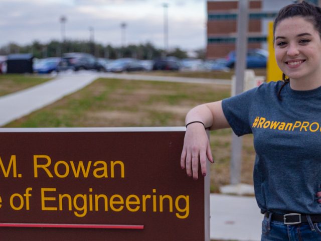 Kelly outside Rowan College of Engineering sign outside