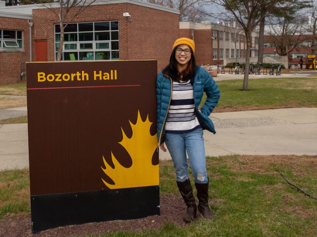 Student Jessica outside Bozorth Hall sign at Rowan University at Glassboro