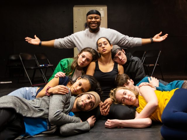 Kerry and cast on the stage in the blackbox theater at rehearsal