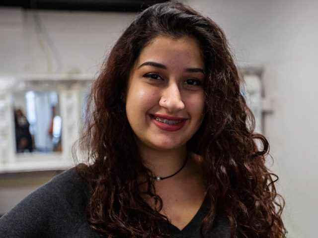 Salma sitting at the piano inside Bunce