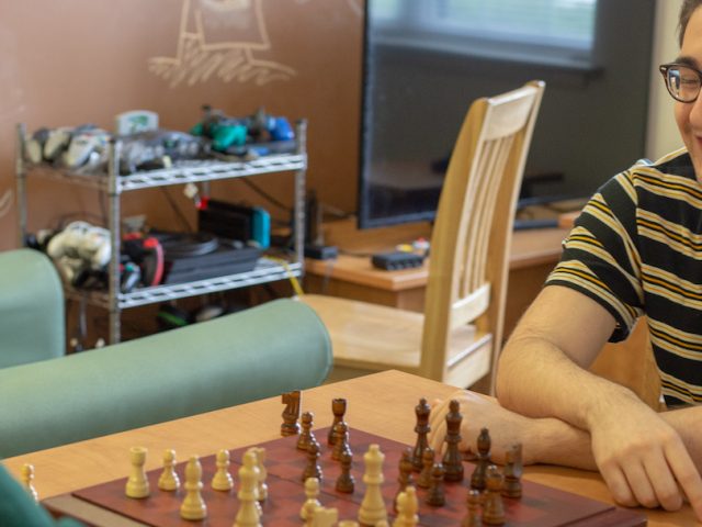 two roommates inside playing chess