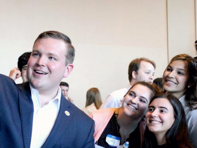 Rowan University alumnus Bill Moen taking a selfie with supporters at a political event.