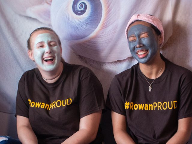 Two students in a dorm room doing face masks together