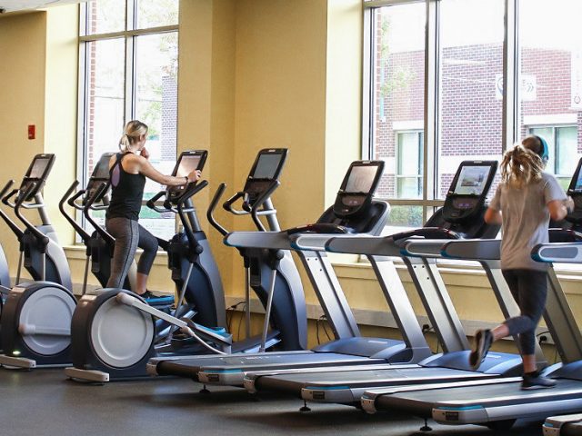 Several students working out on treadmills in a fitness center