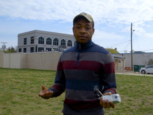 Rashaun Brown stands outside in the vacant lot.