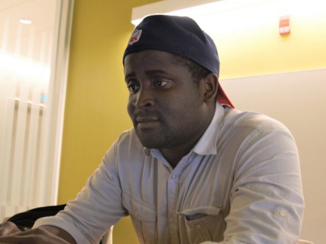 A computer science and mathematics major is sitting with his laptop doing some work.